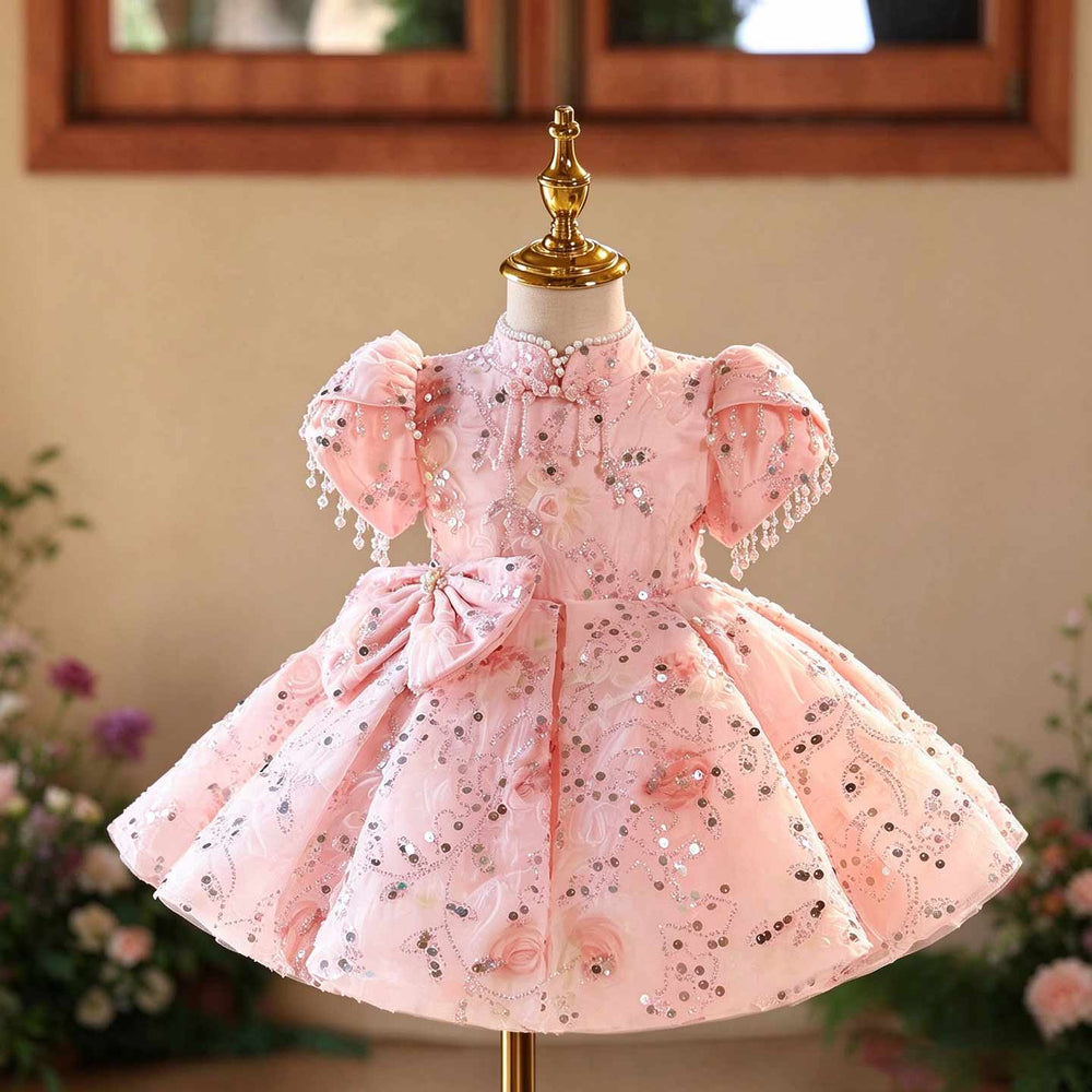 Front view of pink D605 girls birthday dress with stand collar, bead fringe puff sleeves and full short skirt